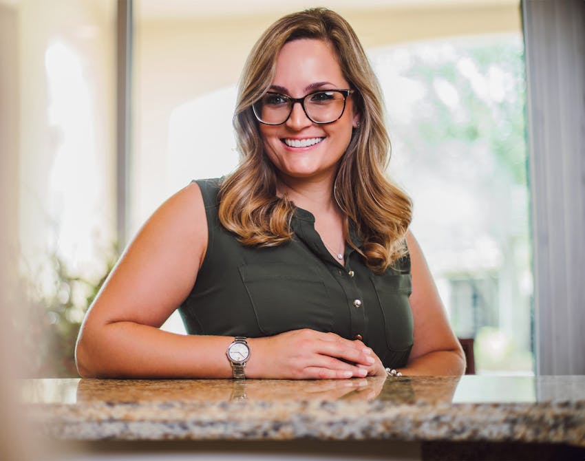 woman in a green top smiling