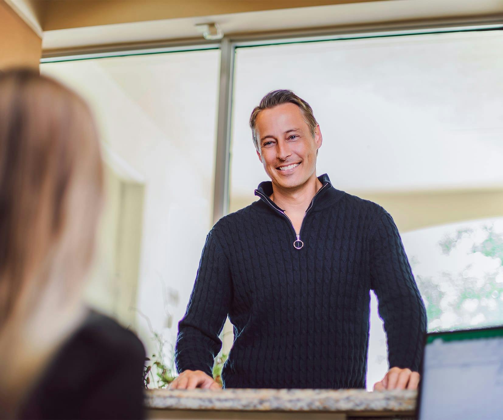 happy patient smiling at front desk