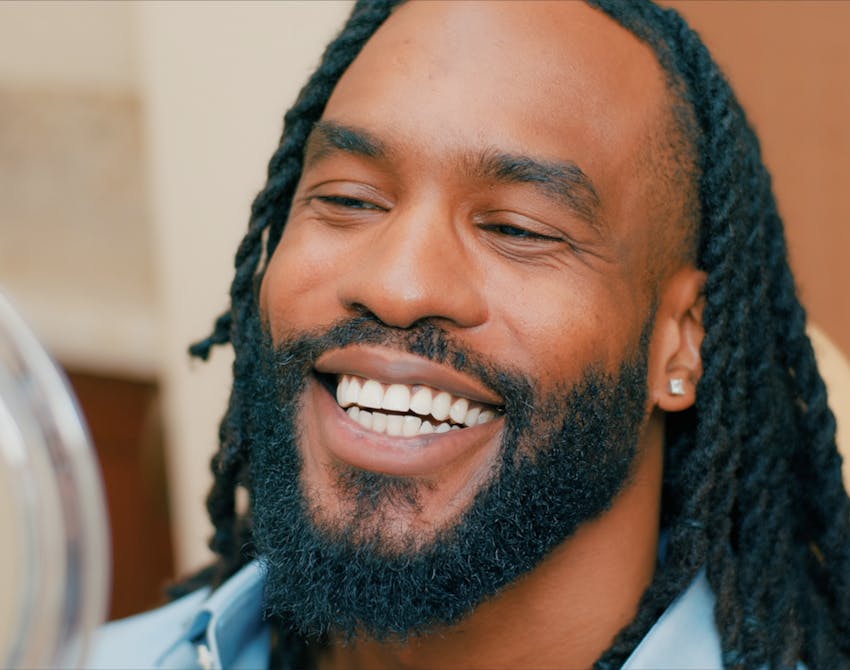 man wearing a black sweater sitting down