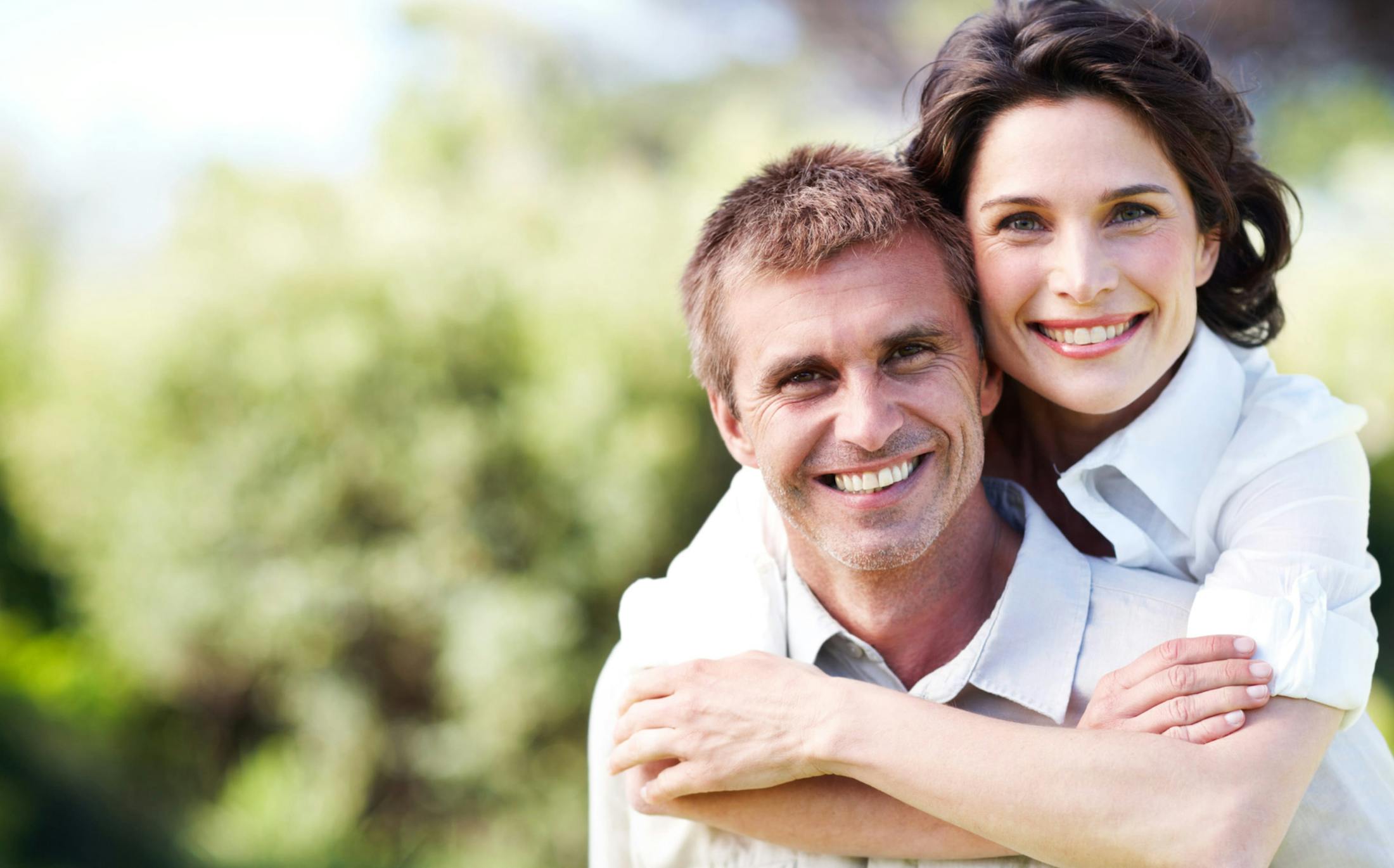 Smiling couple embracing outside