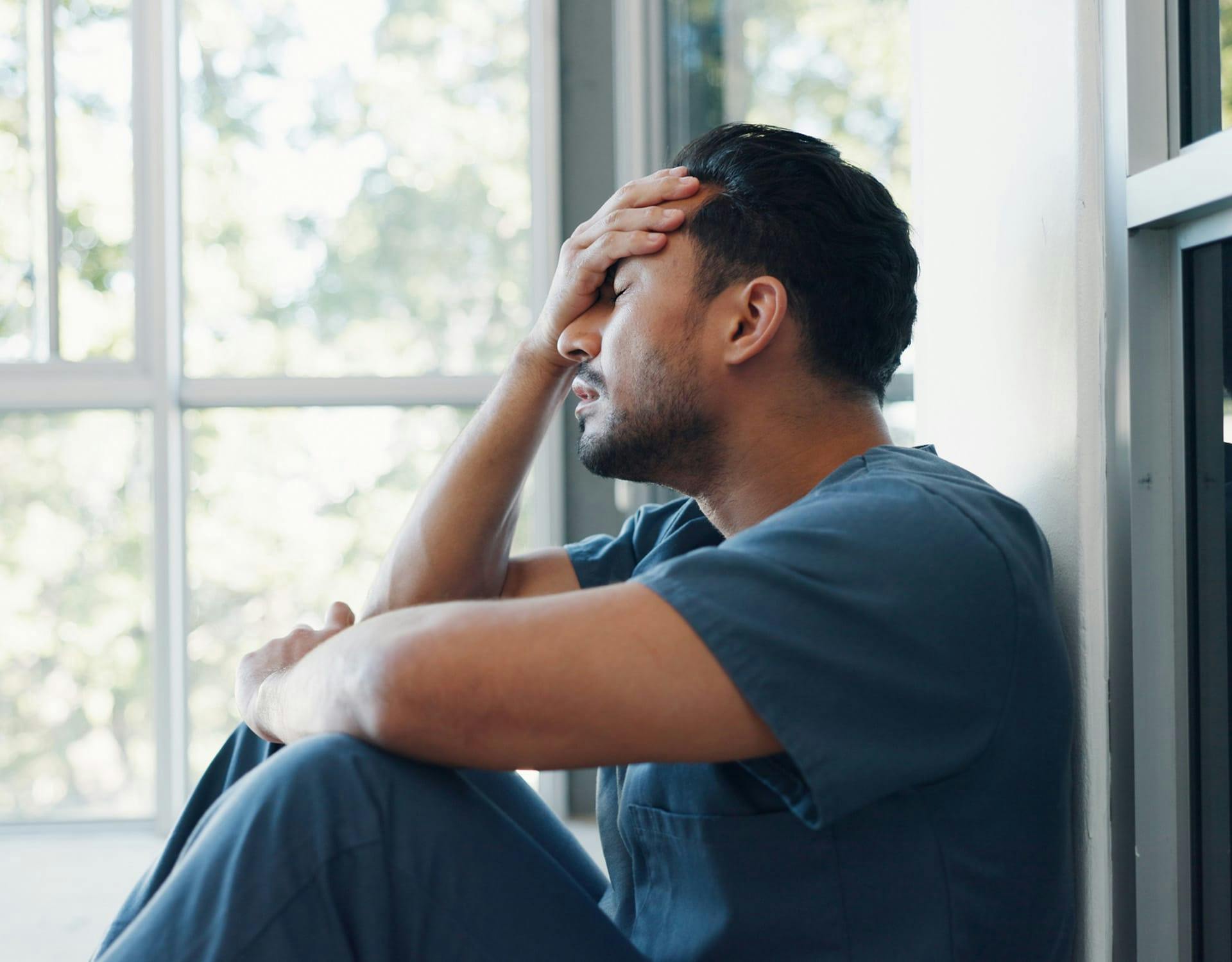 Man holding hand on head