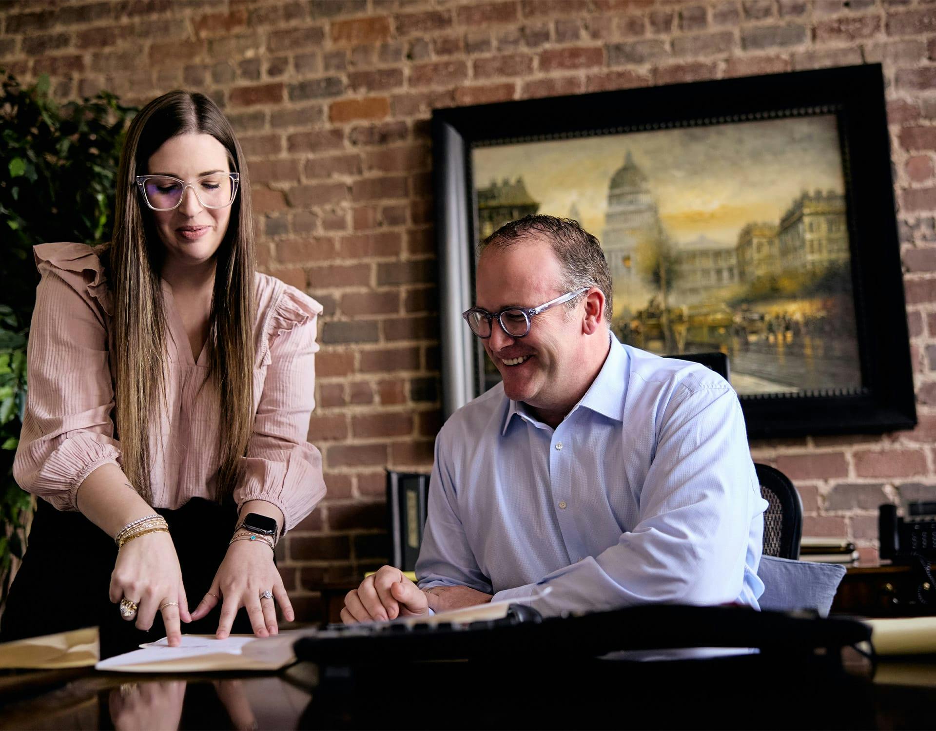 man and woman looking at paperwork on table