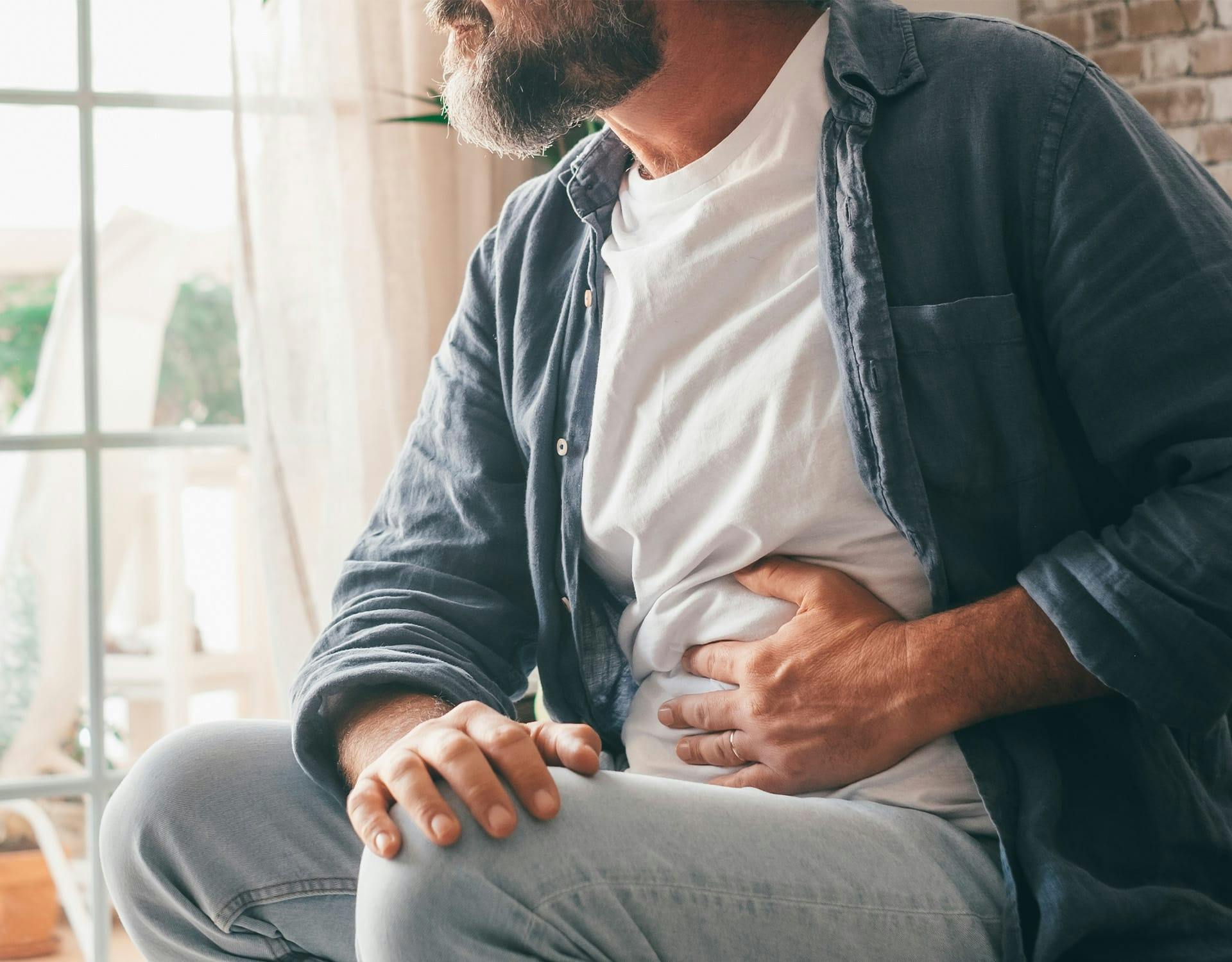 man holding his stomach in pain