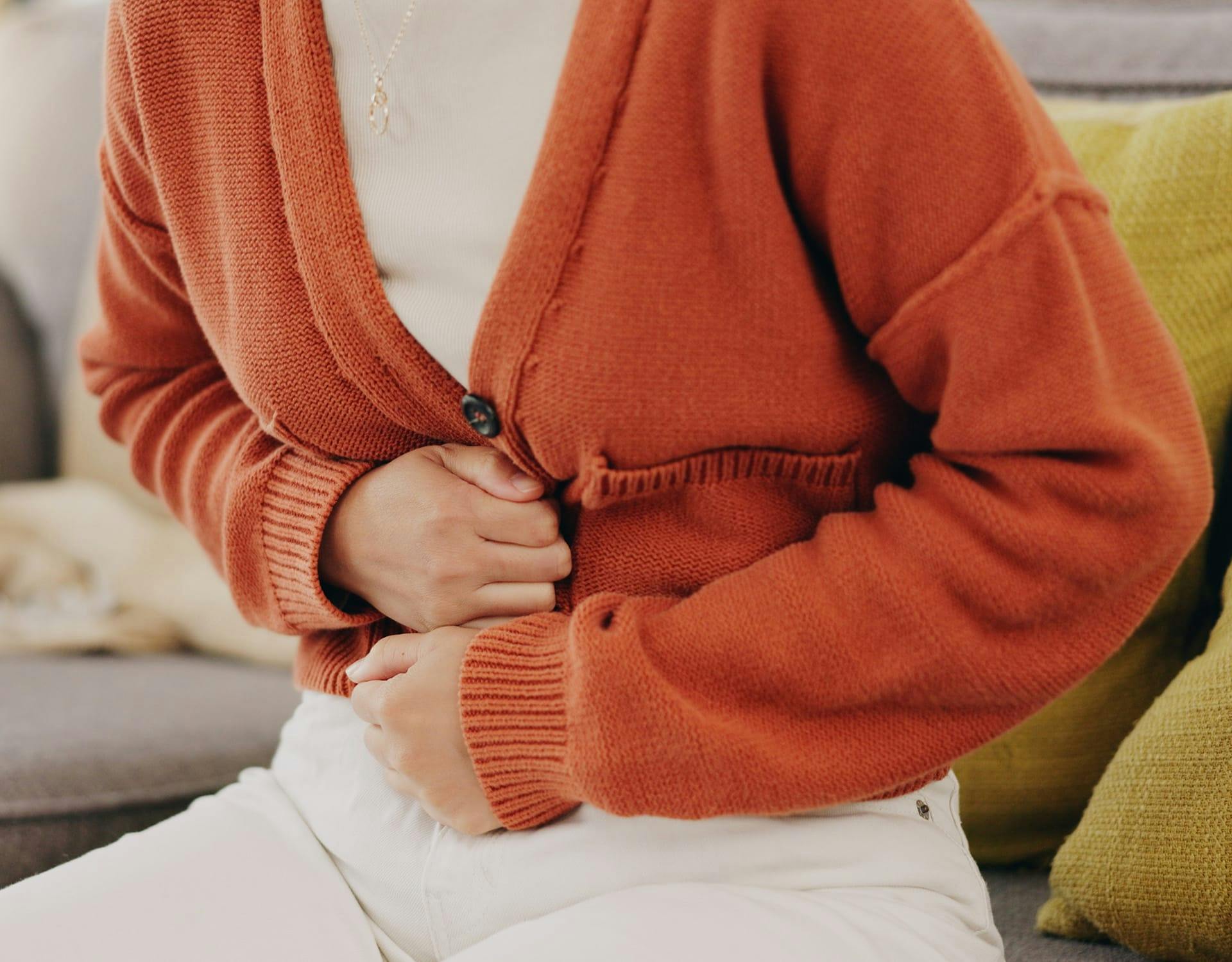 person holding their stomach in pain