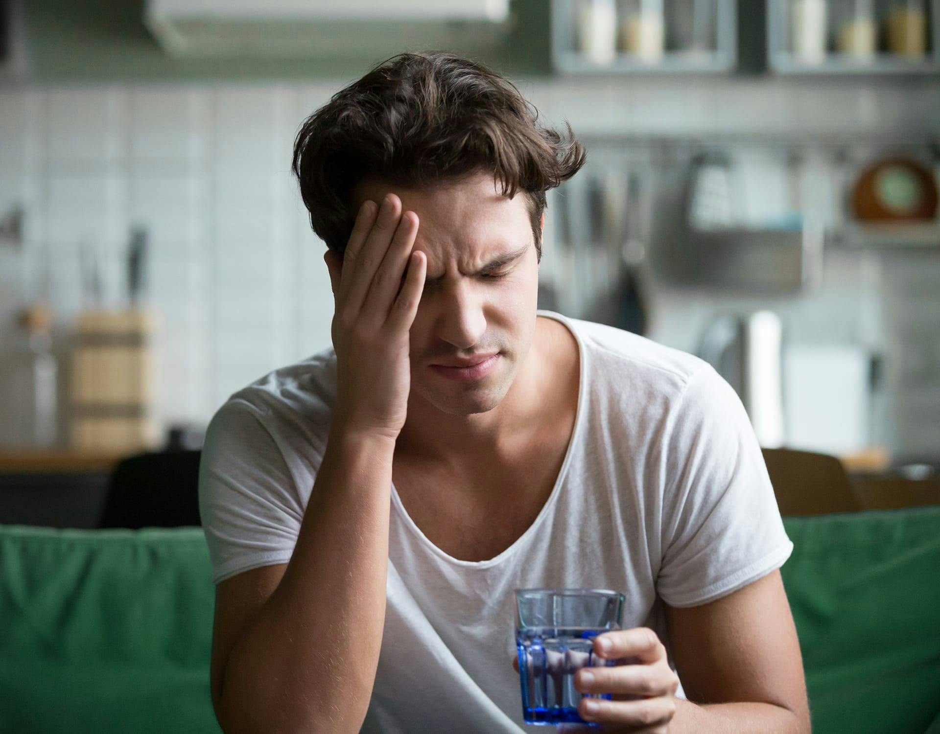 man holding his head in pain