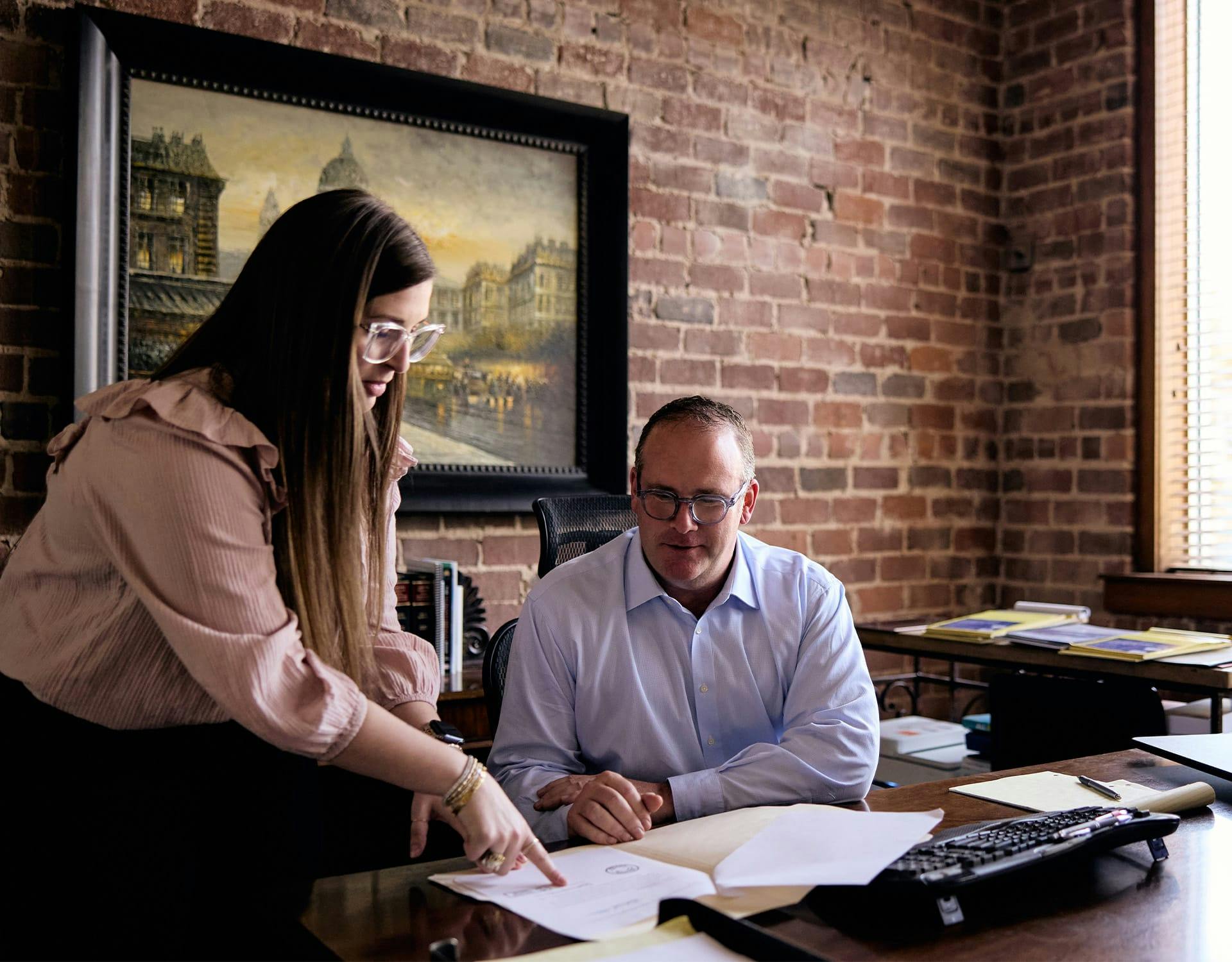 man and woman looking at a document