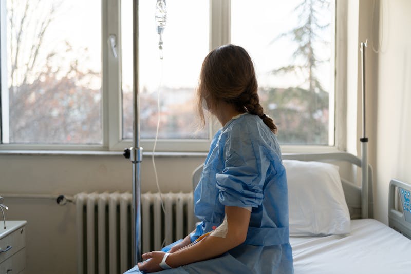Woman sitting on hospital bed