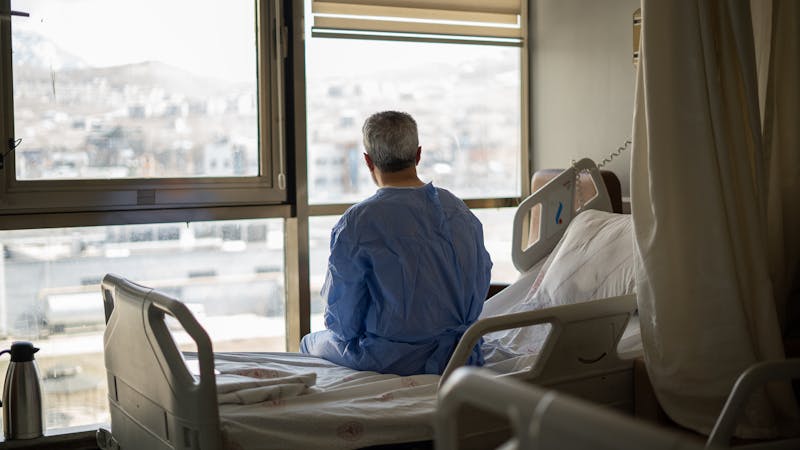 Man sitting on hospital bed