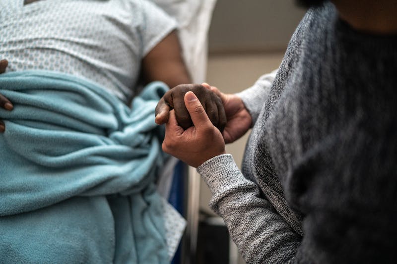 Person holding patient's hand