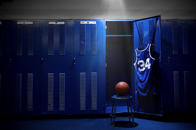 An open locker with a jersey and ball in a authentic basketball locker room