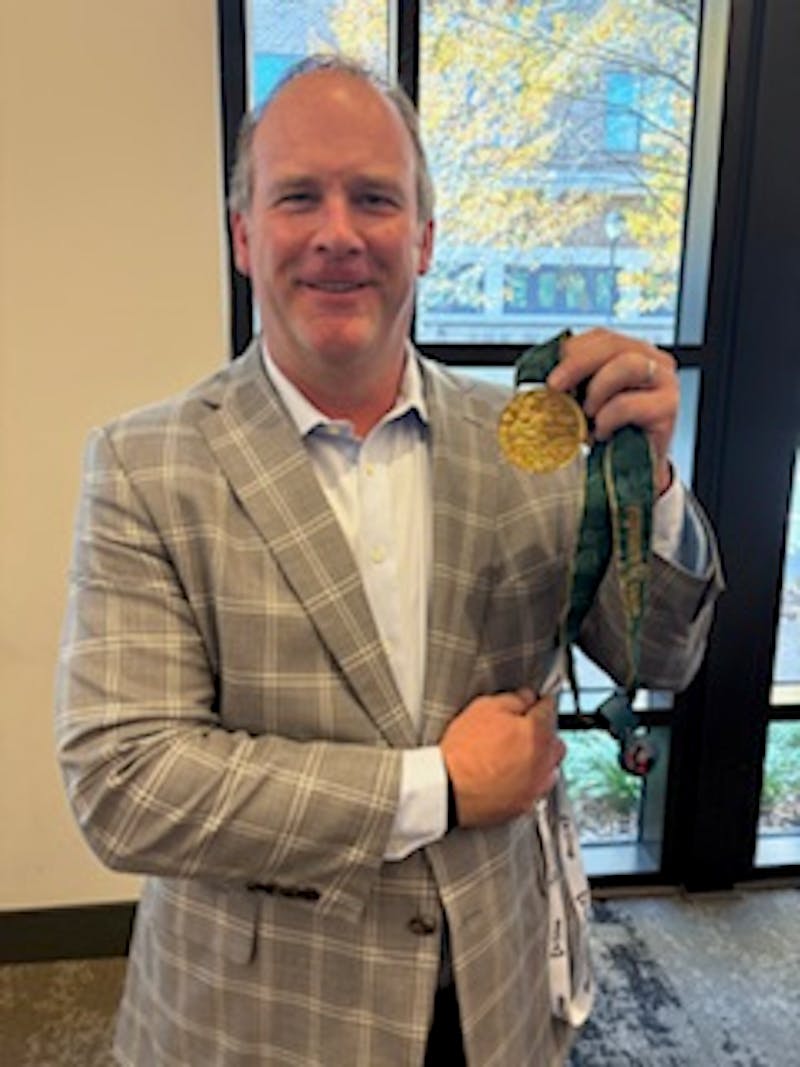Erik with Dominique Dawes's Olympic gold medal