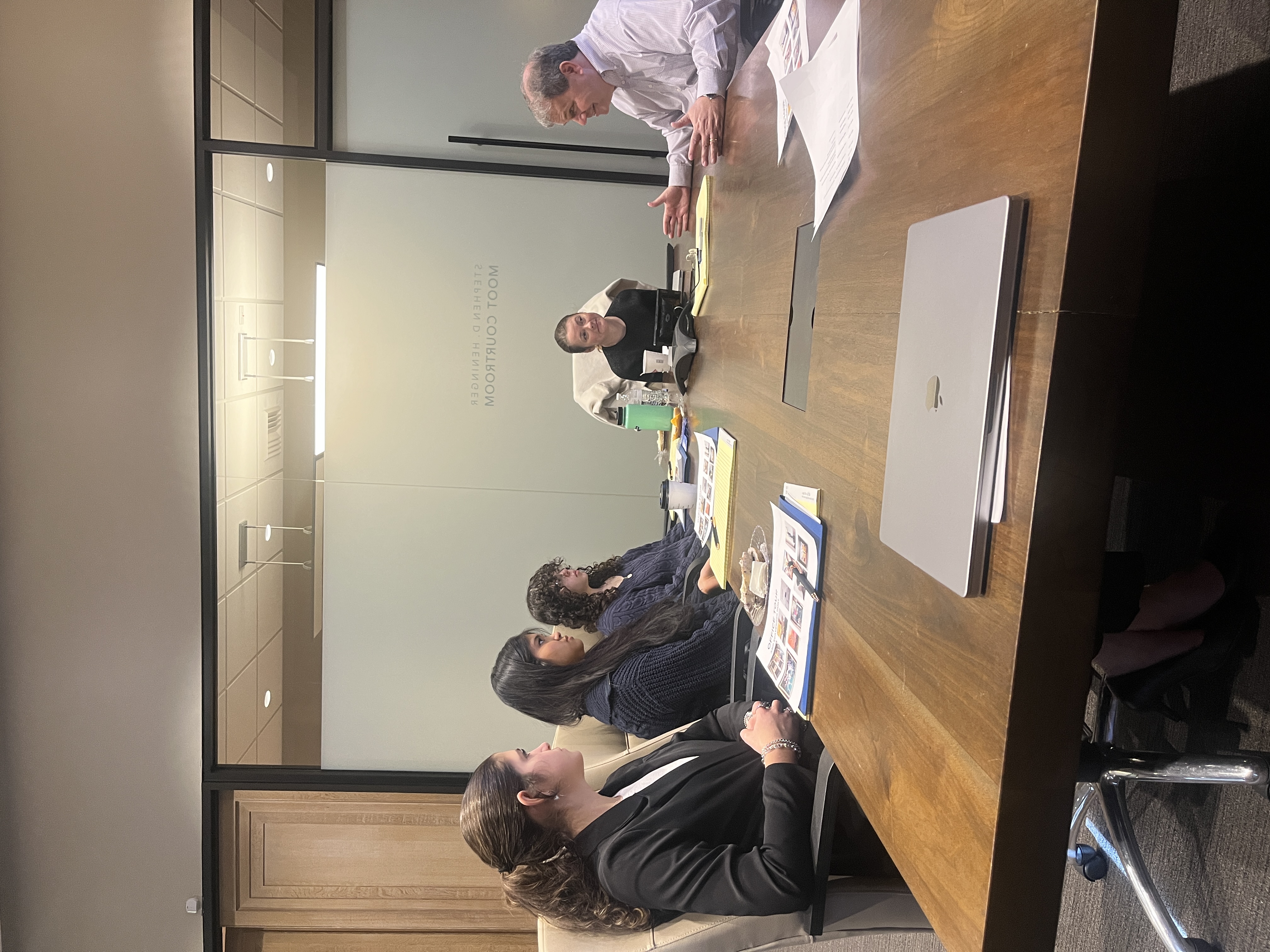 Jay talking to group of students at a table