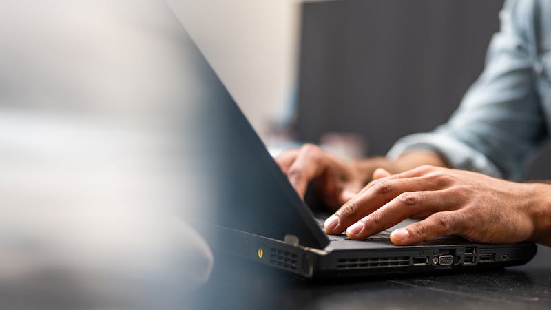 A man typing on computer