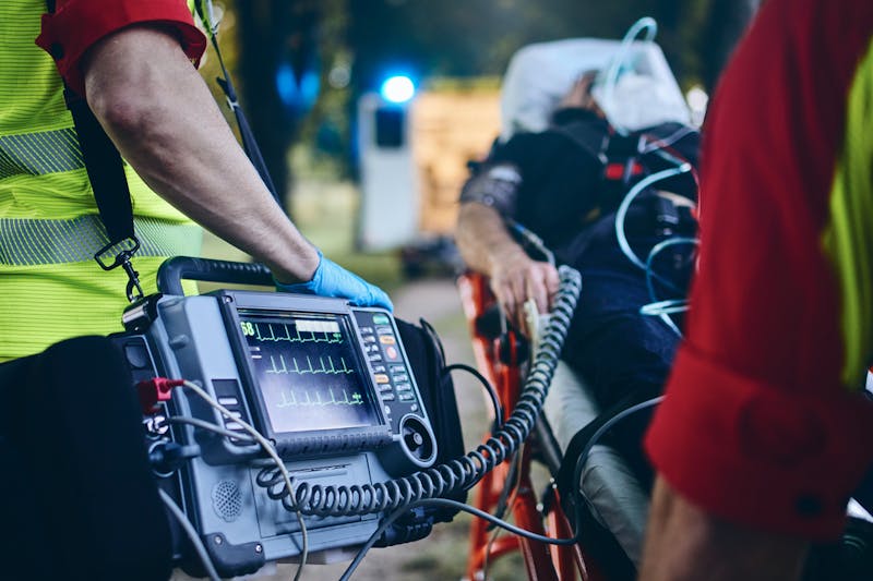 A person on a stretcher with paramedics