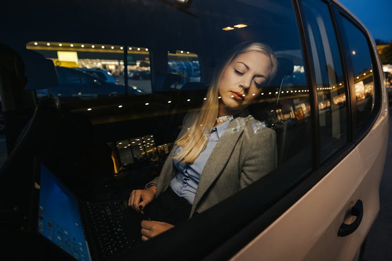 woman sleeping in backseat of car