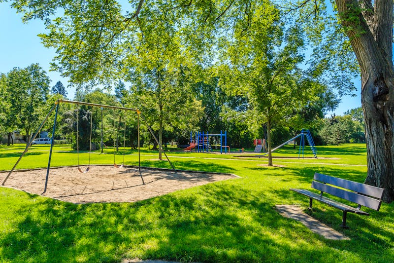 Children's playground and park bench on a sunny day