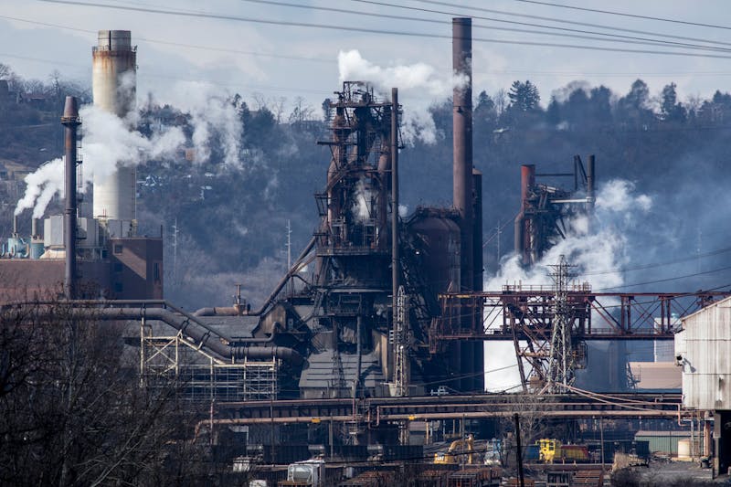 Operating steel mill spewing smoke in the daylight