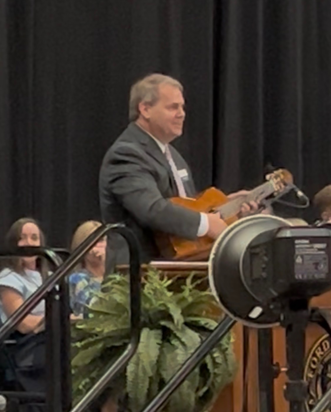 Jay Stewart playing guitar in speech