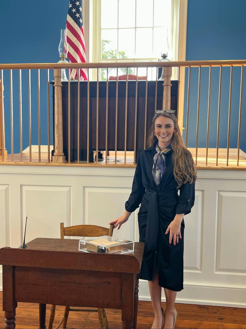 Anabel standing next to a historical desk