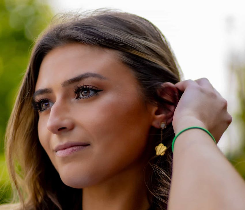 Woman brushing hair behind hear
