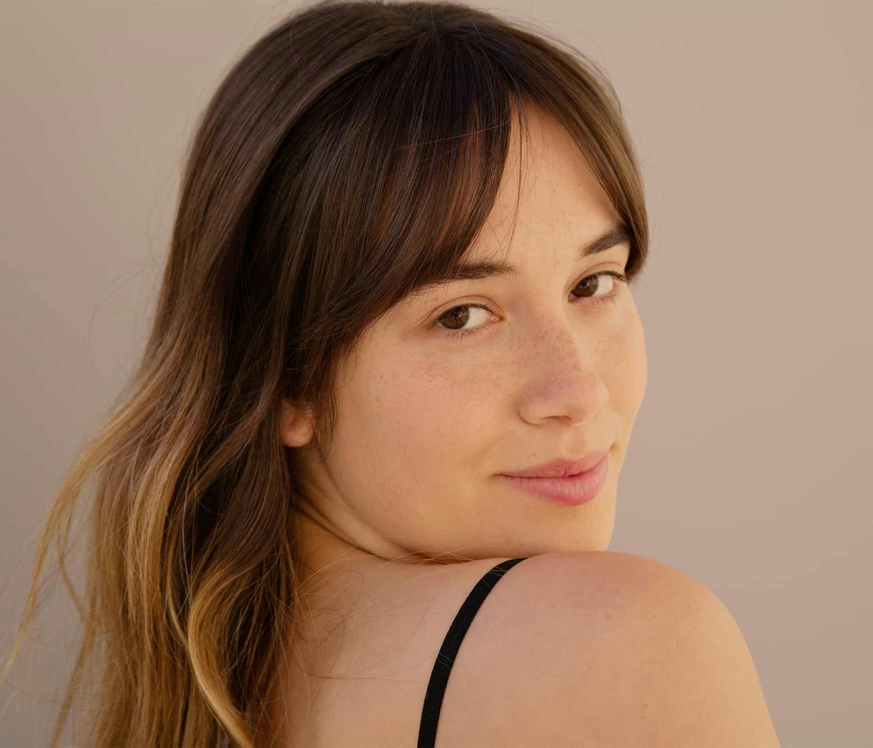Woman looking over shoulder smiling