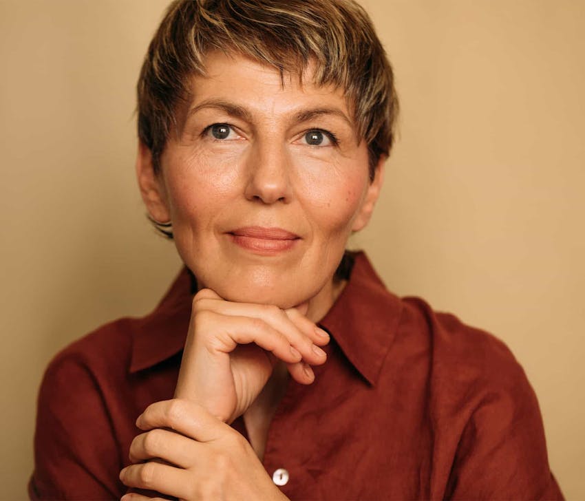 Woman with hand on hand smiling