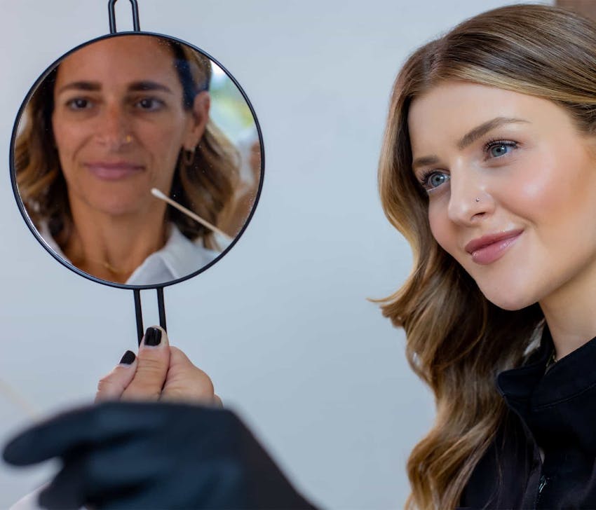 nurse and patient looking in mirror