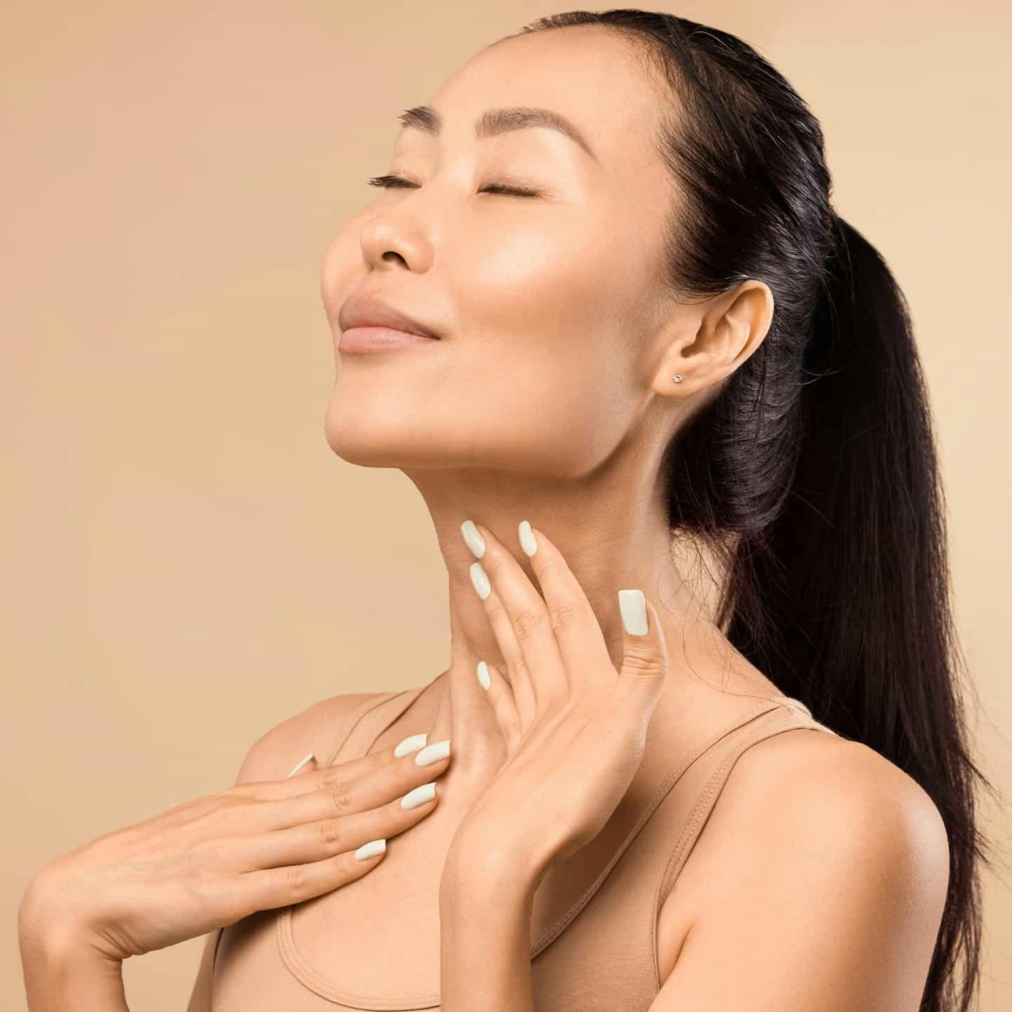 Woman rubbing neck and smiling