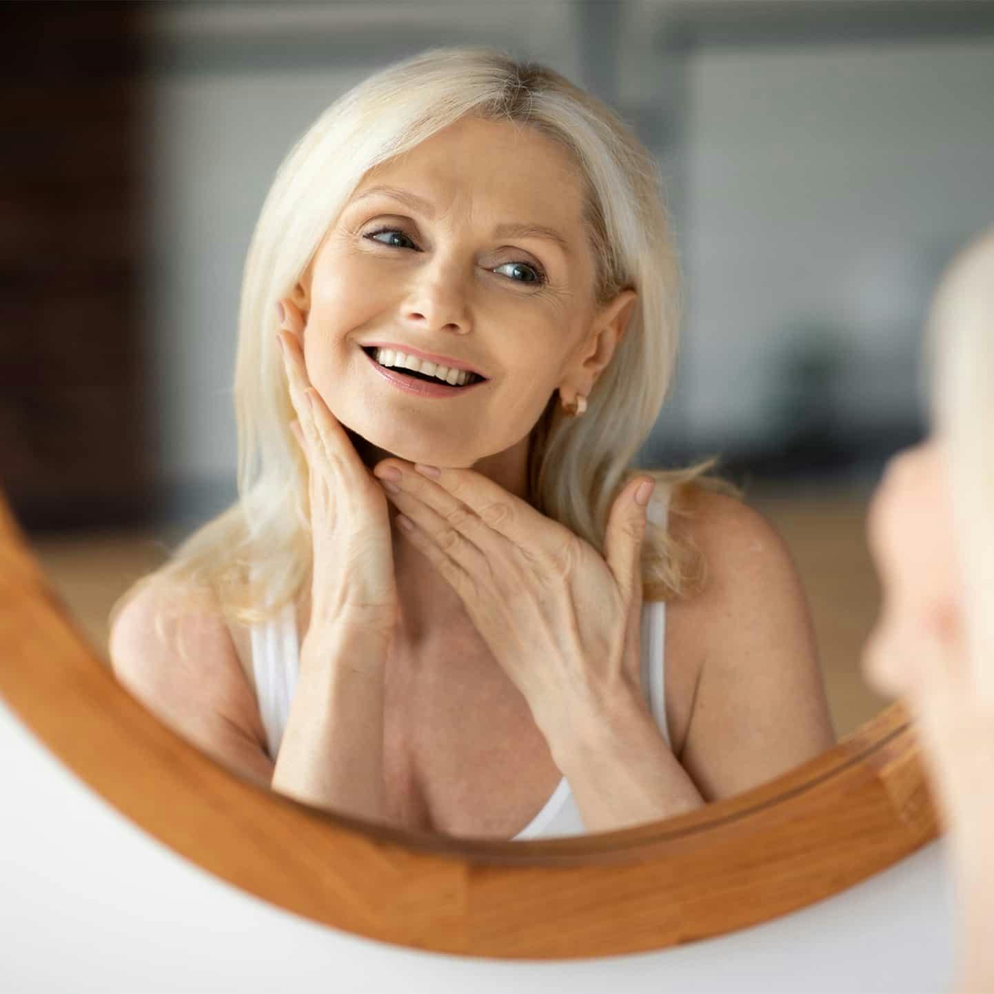 Woman looking in the mirror smiling