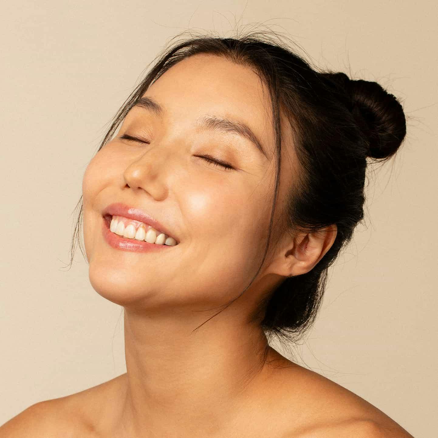 woman smiling with eyes closed