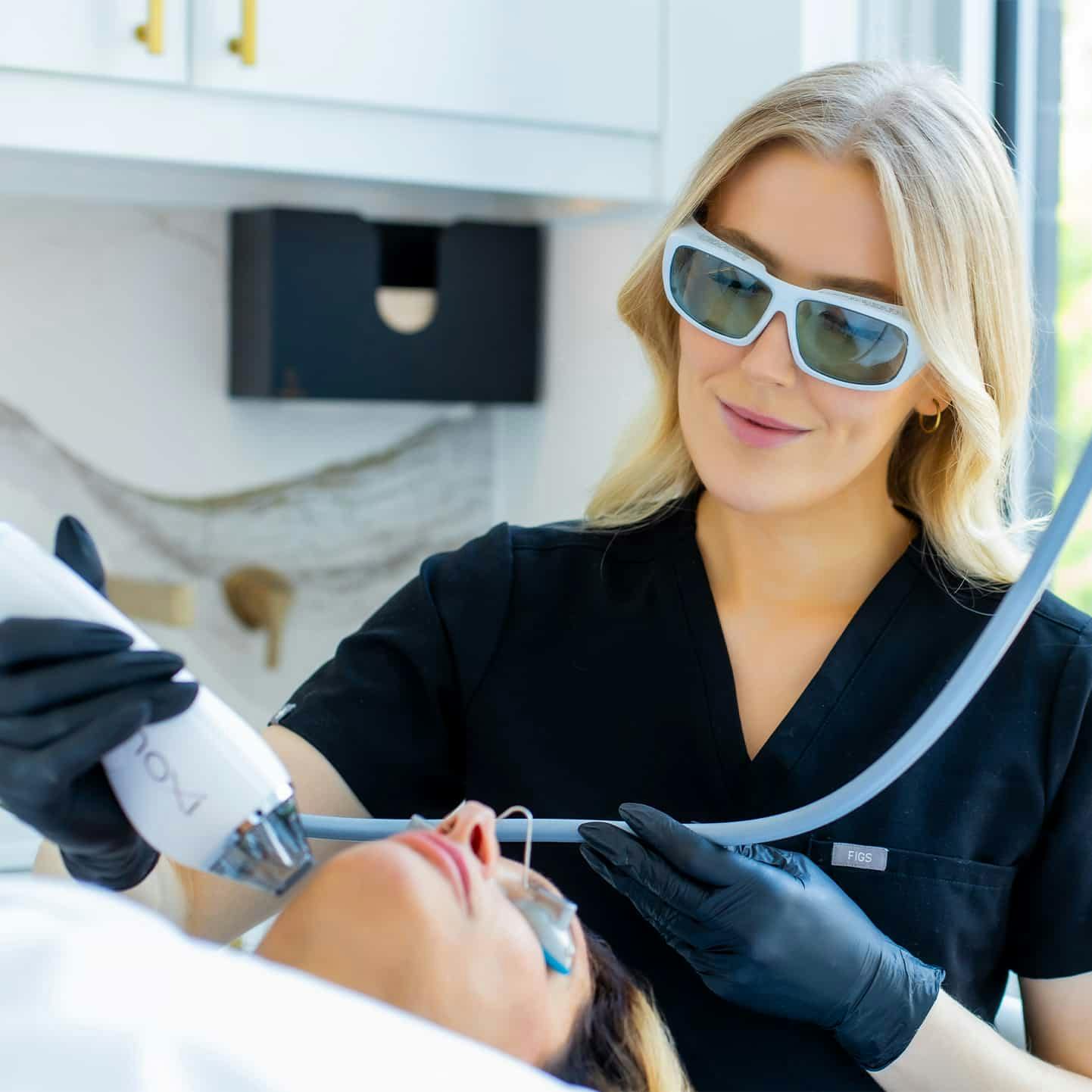 Nurse treating patient with laser
