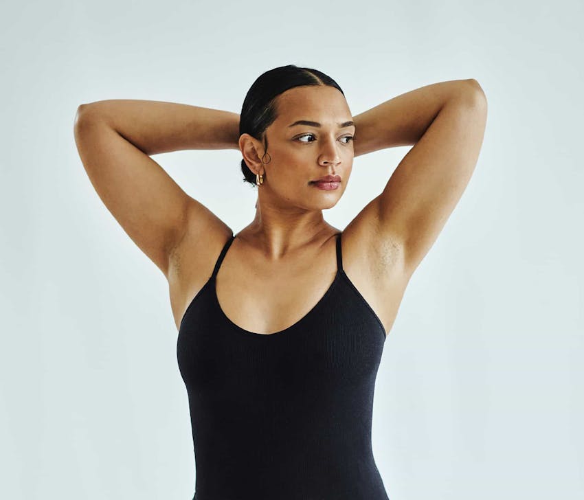 Woman with hands on head