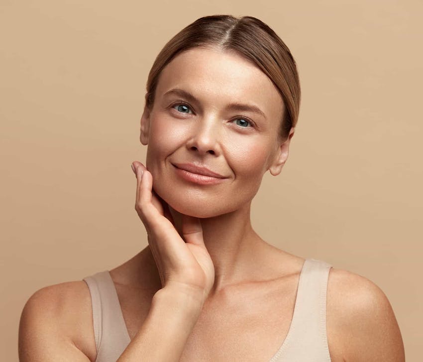 Woman smiling touching face