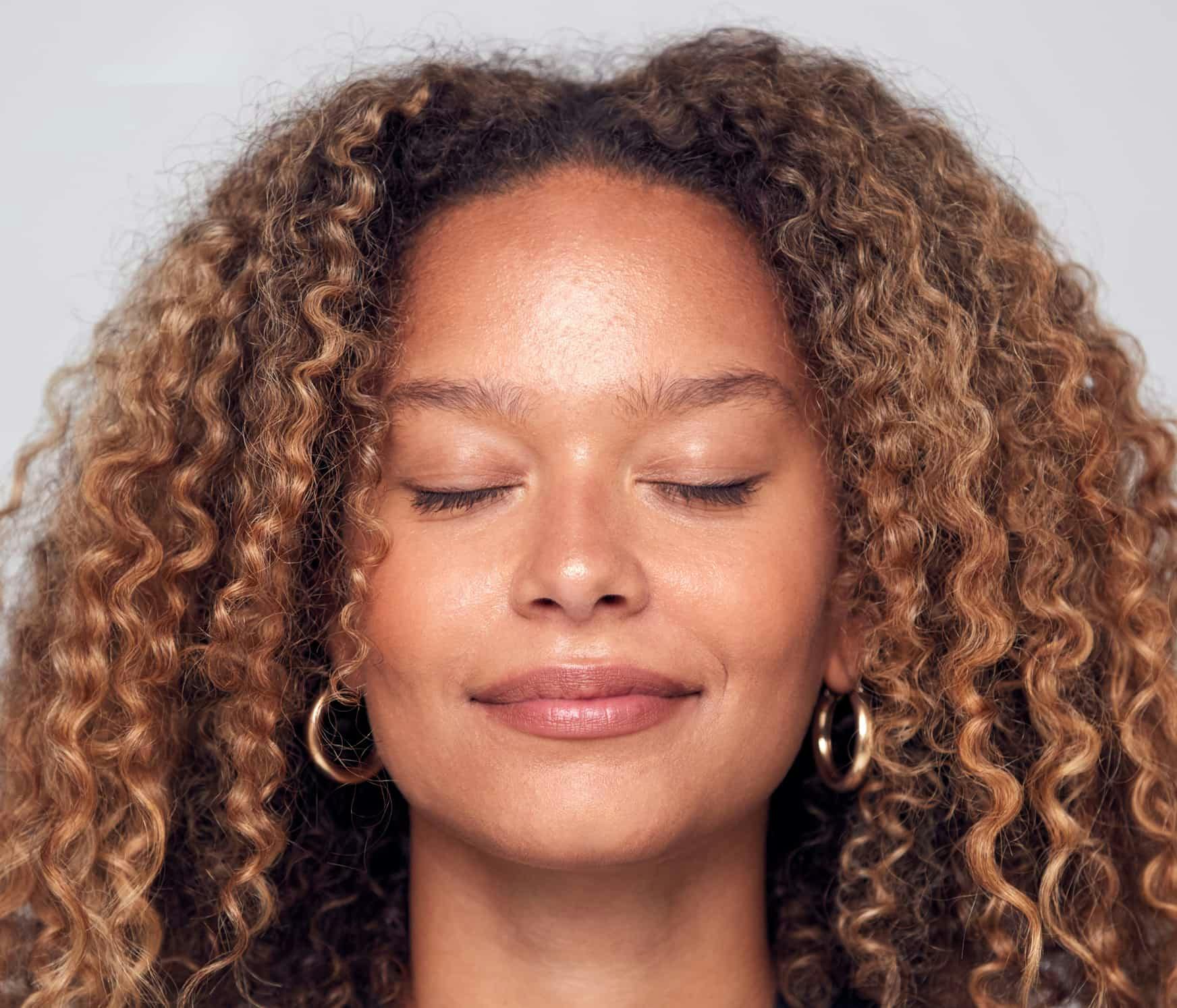 Woman smiling with eyes closed
