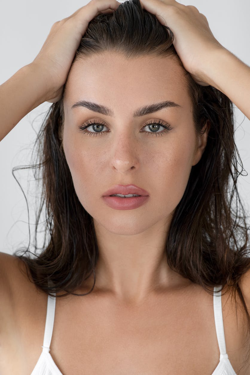 A woman holding back her hair