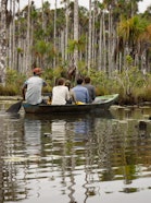 People on a small boat in Madre de Dios.