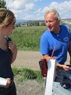 A researcher talks with a vegetable farmer participating in the project.