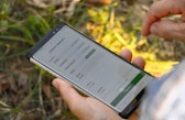 A farmer enters tree information into the Trees4All monitoring system.