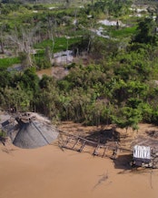 Small-scale gold miners working in the sediment-rich river areas