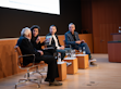 Four people sitting at a panel.