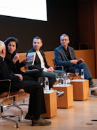 Four people sitting at a panel.