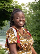 A woman with braids smiling