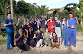 A group of veterinarian students from National University of Laos attending the wildlife training course at LCTW, smiling and gesturing wtih their hands.