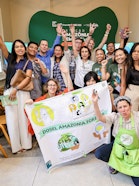 People gathered, holding a poster and in good spirits