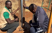 Brian Ayugi and Carlos Nyabuto repairing monitors at the Kuku Site, Kenya
