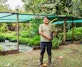 Luis Farfán stands among young copoazú seedlings in an agroforestry nursery.