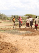 Women from Ol Gaboli restore degraded rangeland by digging semicircular bunds—part of a women-led pilot linking pasture recovery, wildlife connectivity, and local enterprises.