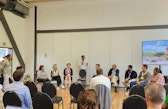 Dr. Miguel Saravia speaks during the SOR4D Conference closing panel, seated with other panelists in front of an audience.