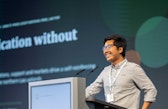 Aye-Chan Maung smiles while speaking at a lectern during his presentation at the 2026 SOR4D Conference.