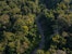 Drone view of the Madre de Dios River, a wide tropical waterway flowing through the Peruvian Amazon, surrounded by dense rainforest and natural wildlife habitat